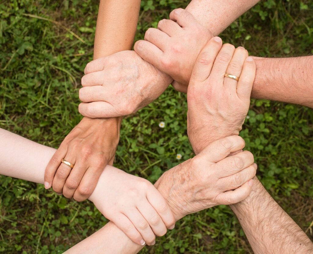 People holding hands supporting each other